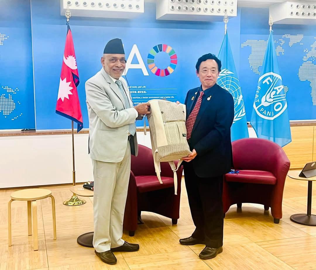 the Honorable Minister of Agriculture and Livestock, Ram Nath Adhikari, presented the Yatra backpack—crafted from banana fiber by EcoKanduk Venture—to Mr. Qu Dongyu